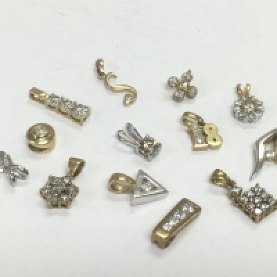 Thirteen 9ct gold and diamond set pendants, total approx 9.3g. Shipping category A.