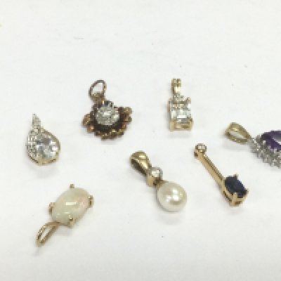 Seven 9ct gold pendants set with stones, total approx 4.4g. Shipping category A.