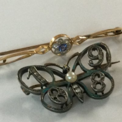 A 15ct gold brooch inset with small sapphire surround by diamond chips of floral design, together with a 1908 brooch in the form of a butterfly