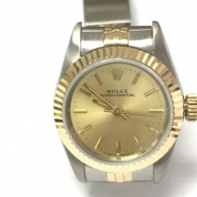 A ladies Rolex Oyster perpetual ref 67193 with gold and steel case and strap and a champagne dial. 26mm case. Watch in very good condition seen running. Comes with box and a 2010 service card. Watch circa 1991. Postage B