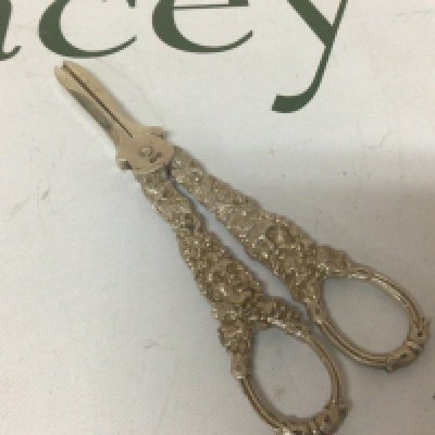 A pair of silver grape scissors with ornate cast handles. London hallmarks.