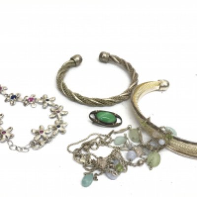 Four silver bangles . Postage category A