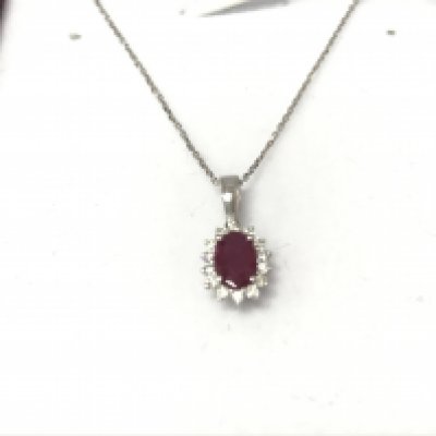 A 9ct white gold oval Ruby and diamond cluster pendant on a 9ct white gold chain. Ruby 0.53ct and diamonds 0.13ct. Postage B
