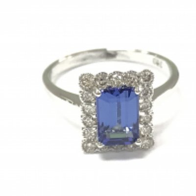 An 18ct white gold ring with emerald cut tanzanite and round cut diamonds. Tanzanite 1.40ct and 0.40ct diamonds approximately. Size M