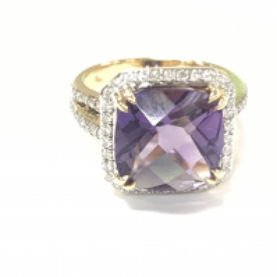An 18ct gold ring set with a large checkerboard cushion cut amethyst surrounded by diamonds and diamond split shoulders. Amethyst 4.90ct and diamonds 0.47ct approximately. Size M 1/2.