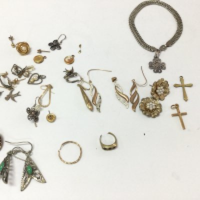 A collection of earrings and pendants including gold and silver examples.