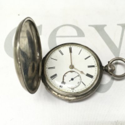 A silver full hunter pocket watch. Not seen running.