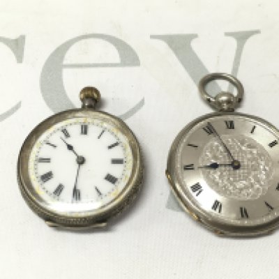 Two silver pocket watches both wind and run.