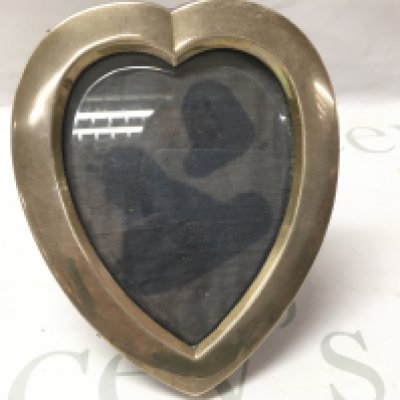A silver heart shaped photo frame. Postage B