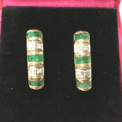A pair of 9ct gold earring set with emeralds and diamonds. Postage B