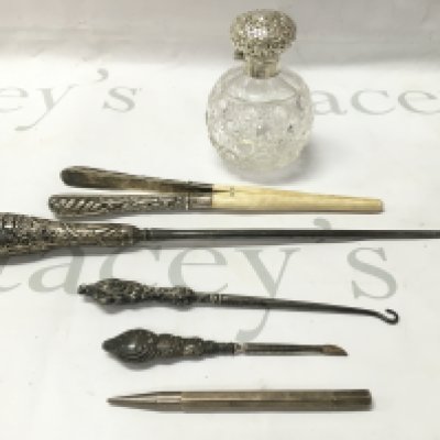 A collection of silver items to include scent bottles pencils etc.