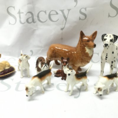 A collection of porcelain beswick figures including a Corgi, Bulldog, Chihuahua, fox, foxhounds and an Arnoldene Dalmatian dog figure . This lot cannot be posted