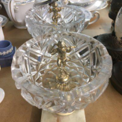 A pair of glass bowls inset with cherubs .on onx bases .