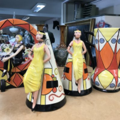 Four Lorna Bailey pottery pieces to include limited edition 1920,s girl seated in a hoop- 87/100, two large Art Deco style sugar shakers with raised figures 249/350 and 313/350 and an Art Deco style jug, decorated with geometric pattern - limited edition 18/150