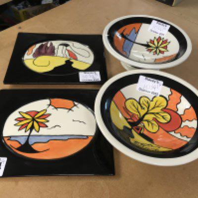 Four Lorna Bailey pottery pieces including dishes on raised feet and two plaques decorated in the Beech and House and Path patterns