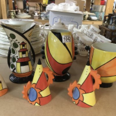 A Lorna Bailey "Flame" vase, a "Pagoda Garden" vase and sugar shaker, a "Sunburst" vase, and two other sugar shakers