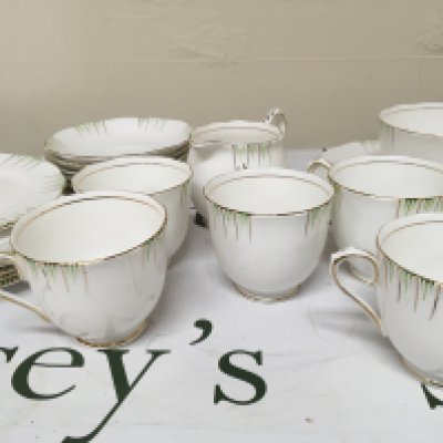 A Royal Albert 1950s design Bone China British tea set six place setting with gilt and green pattern on a white ground. No obvious damage.