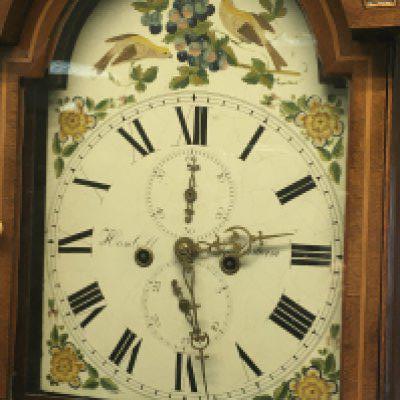 A mahogany long case clock the painted dial with Roman numerals-