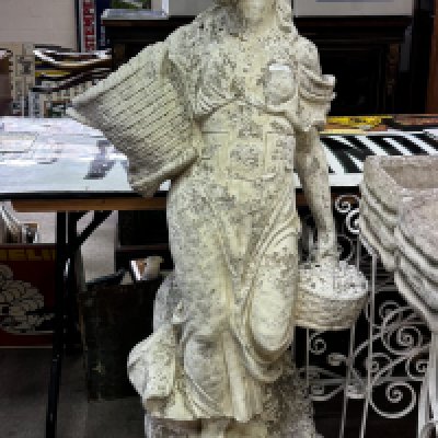 A large cast concrete garden statue of a maiden carrying a basket. 136cm.- NO RESERVE