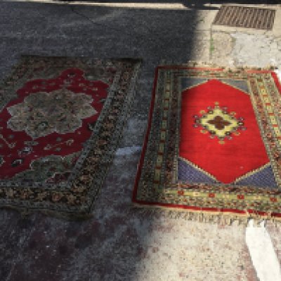 Two red hand woven Rugs. Dimensions 202x130cm and 110x180cm- NO RESERVE