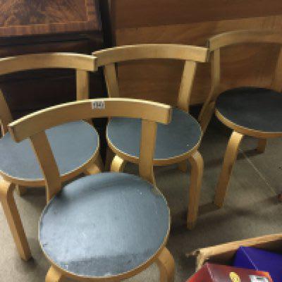 A set of four Alvar Aalto chairs .