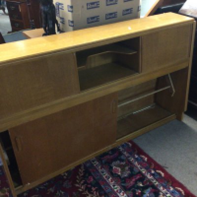 A mid 20th century cabinet with sliding doors. Length 143cm- NO RESERVE