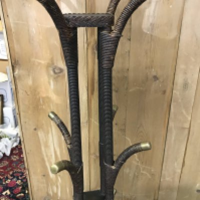 A wicker coat stand United with three tiers.