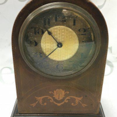 A small inlaid design mantle clock with a Buren Swiss movement. 22cm tall