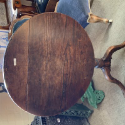 A small oak tripod base tilt topped table.