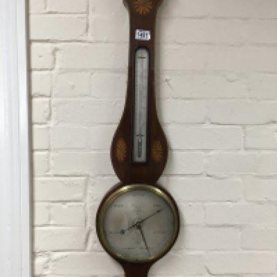 A Georgian mahogany inlaid barometer and a Georgian stick barometer