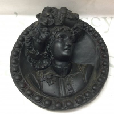 A Victorian plasterwork black plaque , 27cm wide. This lot cannot be posted