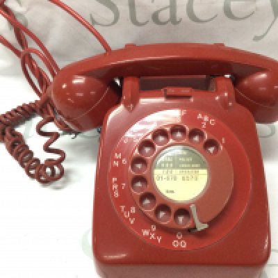 A vintage red telephone . Postage category C