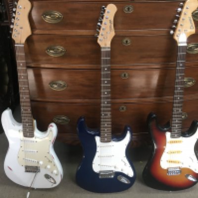 A collection of strat style electric guitars including a Stagg and a Columbus. Including one gig bag. This lot cannot be posted