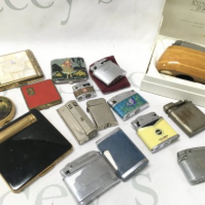 A collection of lighters and compact mirrors . No reserve. Postage category B