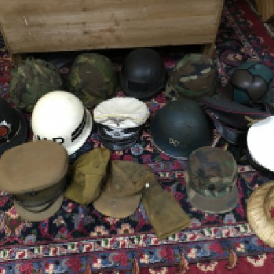 A collection of retrospective military helmets and hats including a Luftwaffe white topped cap, soviet Afghanistan hat