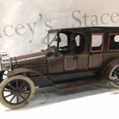 A Vintage clockwork tin model of a 6-light limousine. 35cm long 17.5cm tall Postage cat B