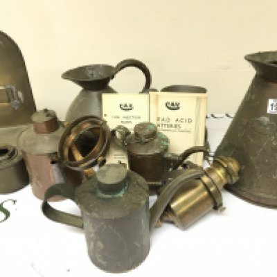A Collection of Antique copper and brass including measuring jugs oil lamp on a gimbal small cans Vintage CAV car service manuals and a box of glass oil lamp shades.