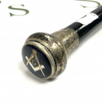 A Silver topped ebonized cane with enamelled Masonic symbol inset int he silver top. 92cm