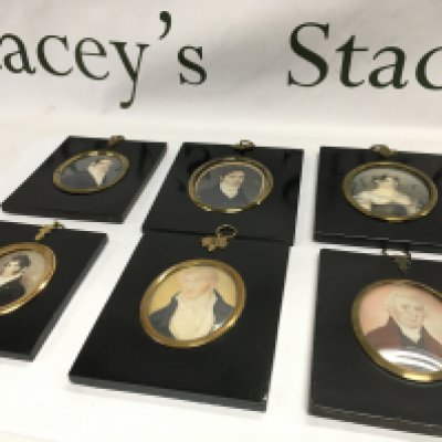 A collection of six 19th century ebonised, framed portrait miniatures including five gentlemen and one lady