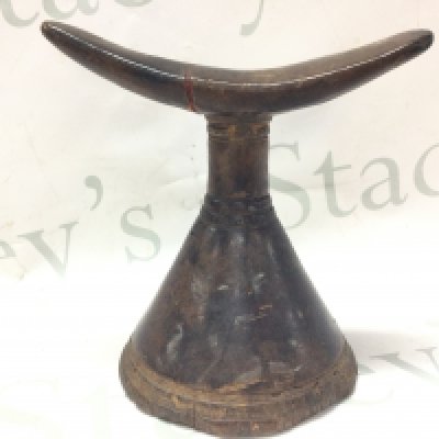 An Ethiopian wooden pillow. 16cm tall. Postage category B