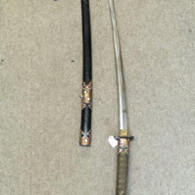 A Japanese Katana with later additional paintwork to the hilt and scabbard copper decoration . 103cm total length blade 72cm long approximately. This lot cannot be posted