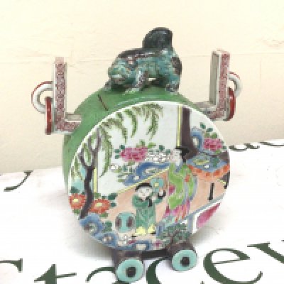 A Chinese porcelain drum shaped incense vase the cover surmounted with a temple dog flanked by raised ring ornamentations. Polychrome decoration with figures and landscape. Character marks to the base. Height 17cm- NO RESERVE