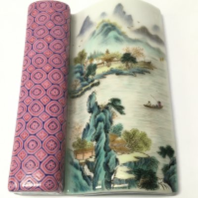 A Chinese wall vase in scroll form depicting a river scene. 7.5cm wide 9.5cm tall This lot cannot be posted