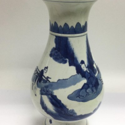 A blue and white vase decorated with figures in a garden setting approximately 35cm