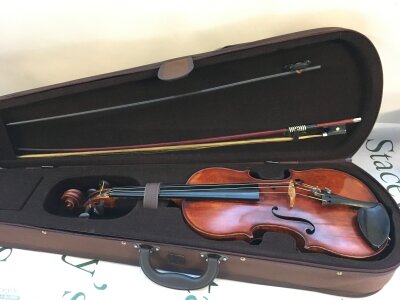 A 1905 cased violin and bow. Haynes of London retailer on label.