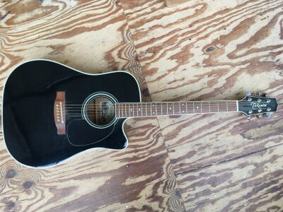A Takamine EF341SC electro acoustic guitar with soft carry case.