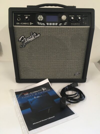 A Fender G Deck Thirty amplifier with lead and manual.