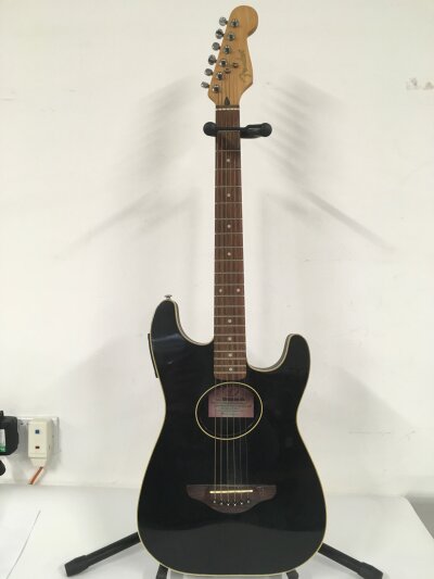 A Fender Stratacoustic electro acoustic guitar with stand (2). No case.