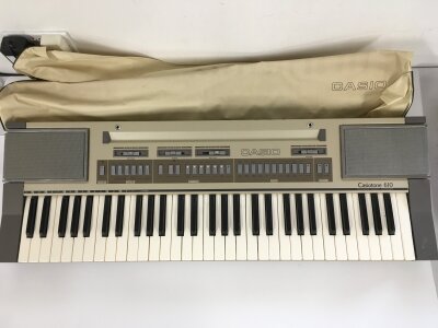 A Casiotone 610 keyboard with original dust cover.