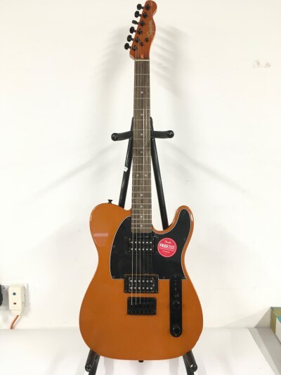 A Fender Squier Telecaster electric guitar with an orange sparkle finish. Comes with a soft carry case.